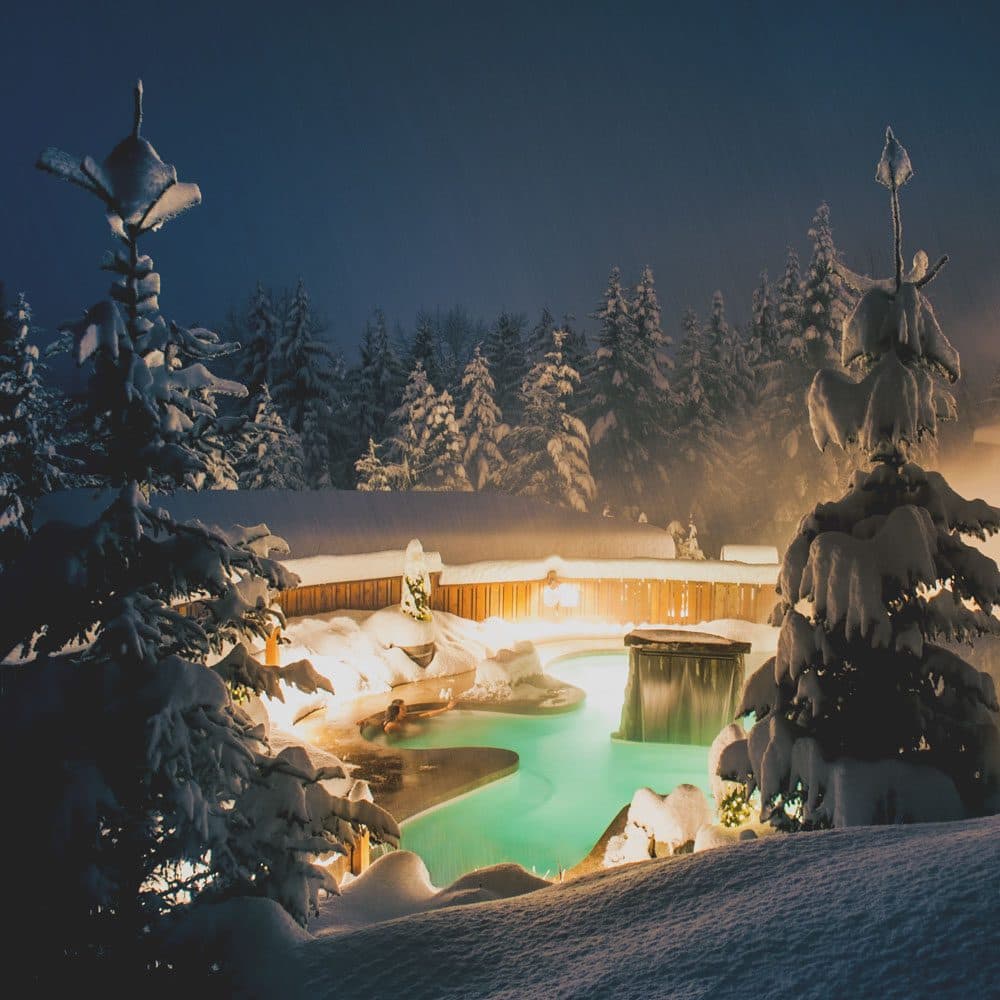 Outdoor spa area at Scandinave Whistler in the Winter at nighttime.